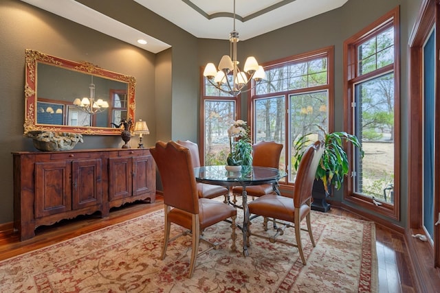dining area featuring a notable chandelier and wood finished floors