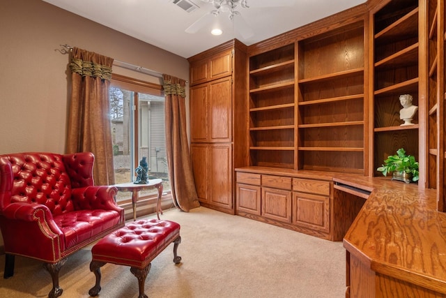 sitting room featuring light carpet, ceiling fan, and visible vents