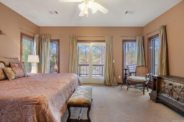 carpeted bedroom featuring access to exterior, visible vents, and a ceiling fan