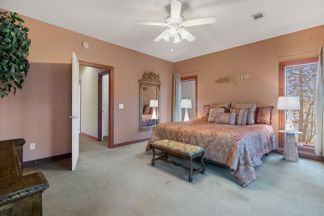 bedroom featuring carpet floors, baseboards, visible vents, and a ceiling fan