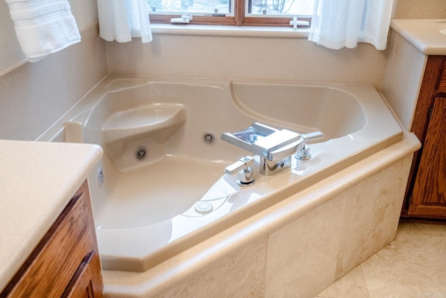 bathroom with a whirlpool tub and vanity