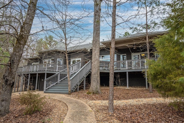 back of property featuring ceiling fan, stairway, and a wooden deck