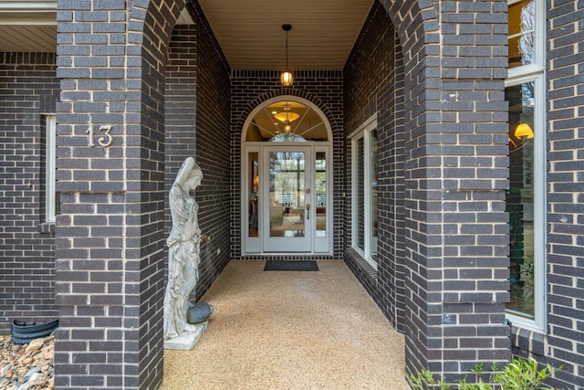 doorway to property with brick siding