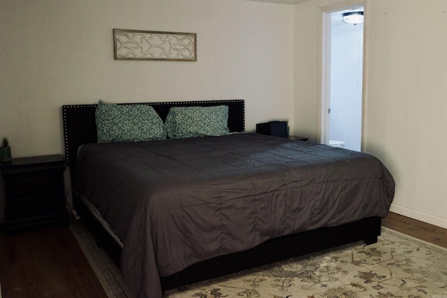 bedroom with wood finished floors and baseboards