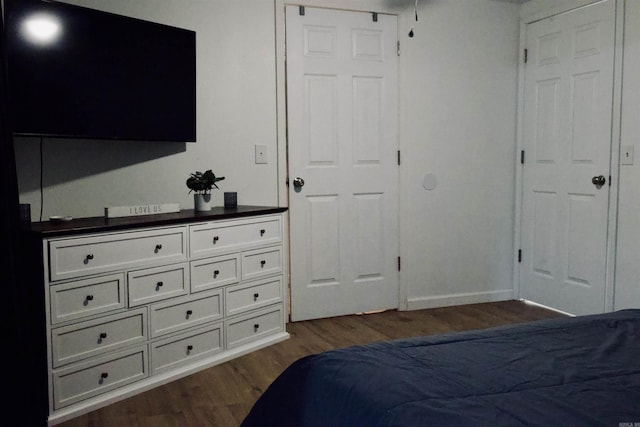 bedroom featuring dark wood-style floors and baseboards