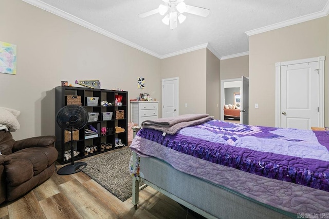 bedroom with ceiling fan, crown molding, and wood finished floors