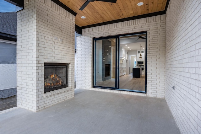 view of patio / terrace with an outdoor brick fireplace and ceiling fan