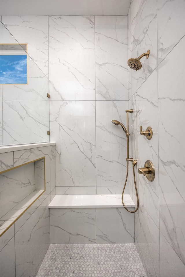 full bathroom featuring a marble finish shower