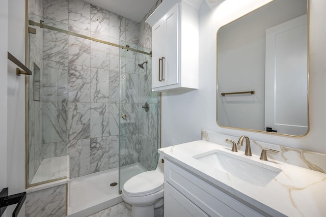 bathroom with marble finish floor, a stall shower, vanity, and toilet