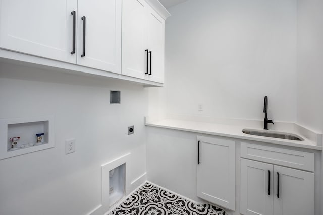 washroom featuring cabinet space, a sink, tile patterned flooring, washer hookup, and electric dryer hookup