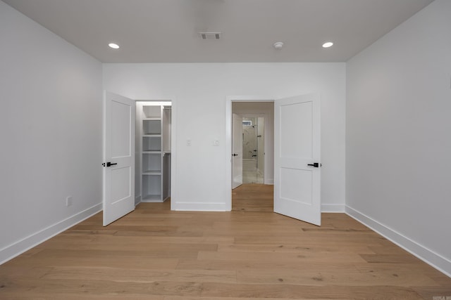 unfurnished bedroom featuring light wood-style flooring, visible vents, baseboards, and recessed lighting