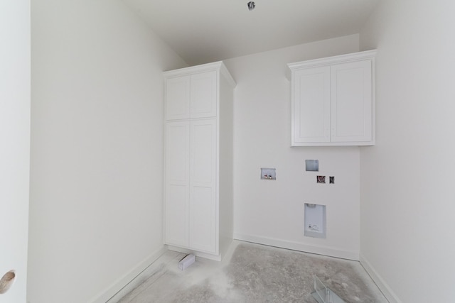 laundry room with washer hookup, cabinet space, and baseboards