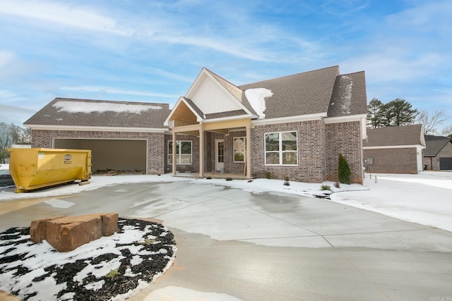 view of front of house featuring a garage and brick siding