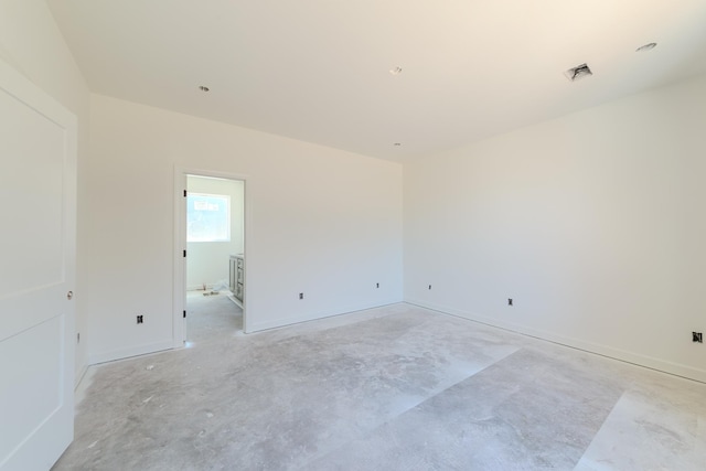 unfurnished room with concrete flooring and visible vents