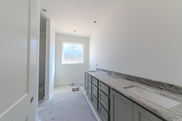 bathroom featuring a sink and double vanity