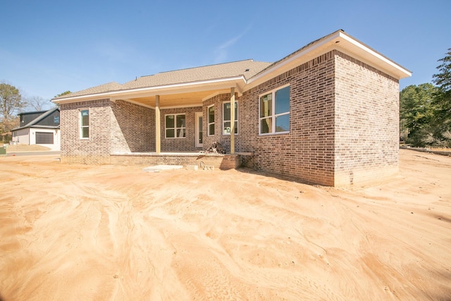 rear view of house featuring brick siding