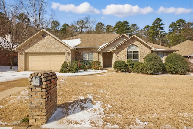 ranch-style house with driveway, brick siding, and an attached garage