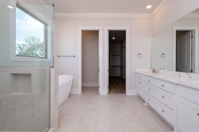 bathroom with a sink, double vanity, a stall shower, and a freestanding tub