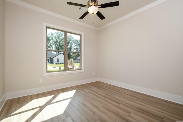 unfurnished room featuring light wood-style floors, crown molding, baseboards, and a ceiling fan