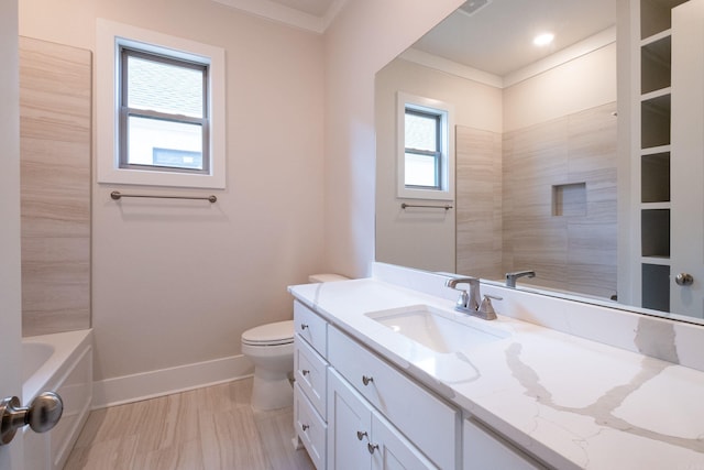 bathroom featuring baseboards, ornamental molding, toilet, and a healthy amount of sunlight