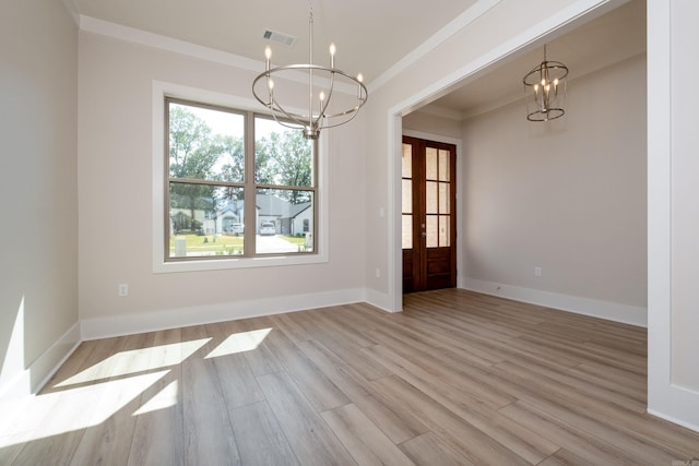 unfurnished dining area featuring light wood finished floors, baseboards, a chandelier, and crown molding