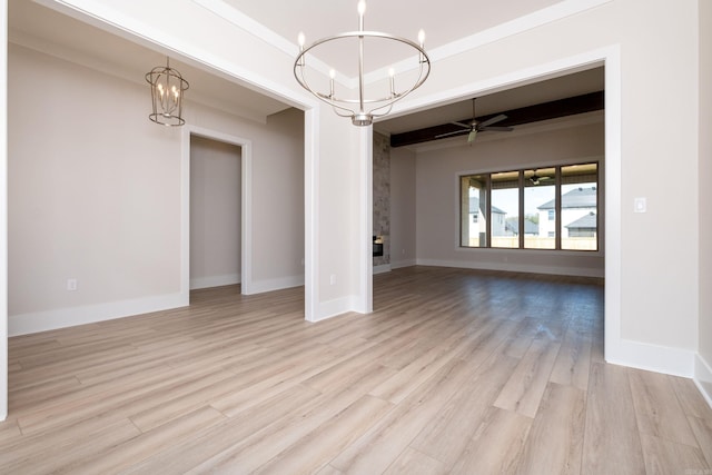 unfurnished dining area with baseboards, light wood finished floors, and ceiling fan with notable chandelier