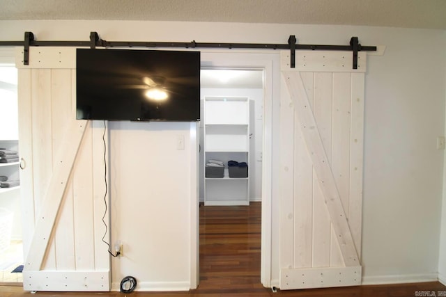 interior space featuring a barn door and wood finished floors