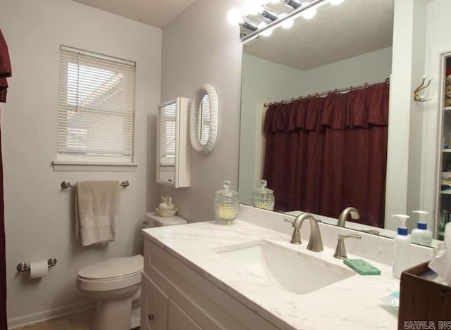 bathroom with toilet, a shower with shower curtain, and vanity