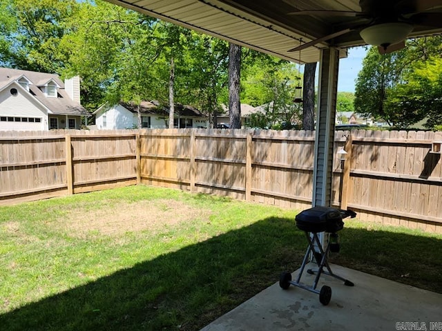 view of yard with a fenced backyard, a ceiling fan, and a patio