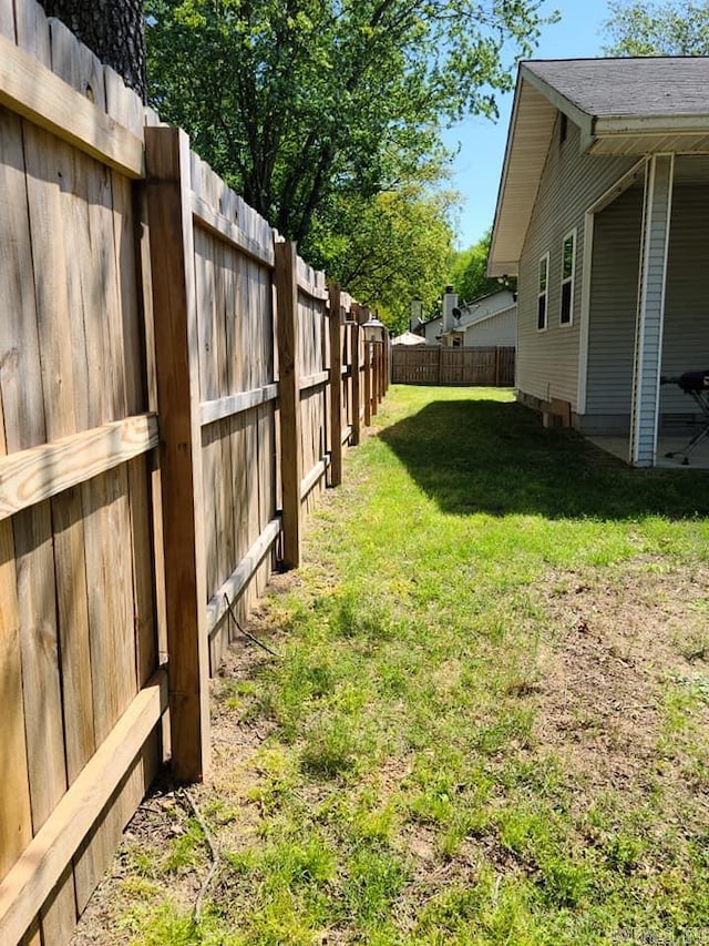 view of yard with a fenced backyard