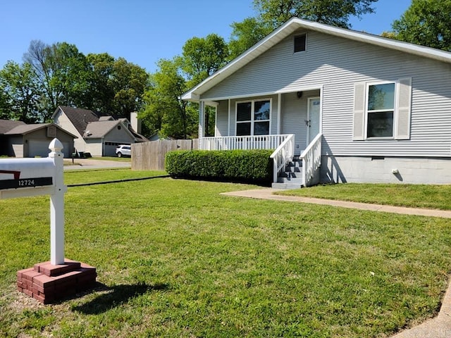 bungalow-style house with covered porch, a front lawn, crawl space, and fence