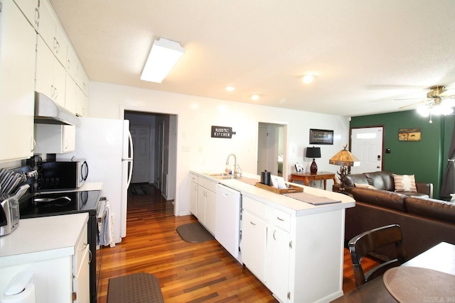 kitchen featuring white dishwasher, under cabinet range hood, range with electric stovetop, open floor plan, and light countertops