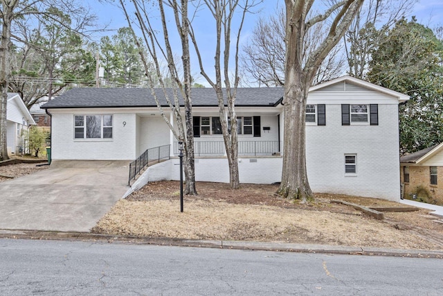 ranch-style home with concrete driveway and brick siding