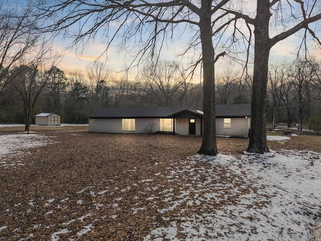 view of front of house with a storage shed and an outdoor structure