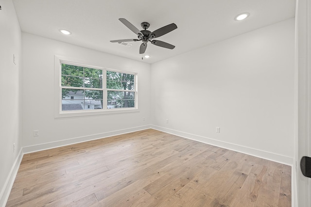 spare room featuring light wood-style floors, baseboards, and recessed lighting