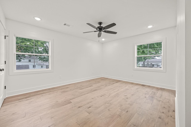 unfurnished room with light wood-style flooring, recessed lighting, visible vents, and baseboards