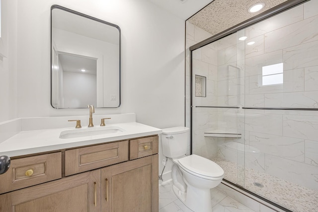 full bath featuring toilet, marble finish floor, a shower stall, and vanity