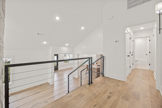 corridor with baseboards, recessed lighting, visible vents, and light wood-style floors