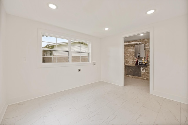 empty room with baseboards, marble finish floor, and recessed lighting