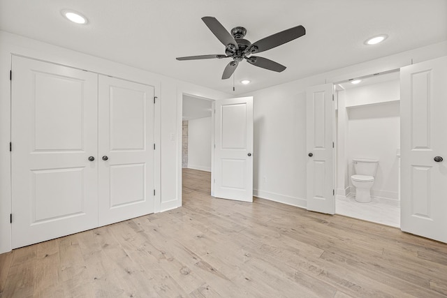 unfurnished bedroom with recessed lighting, light wood-style flooring, a closet, and ensuite bathroom