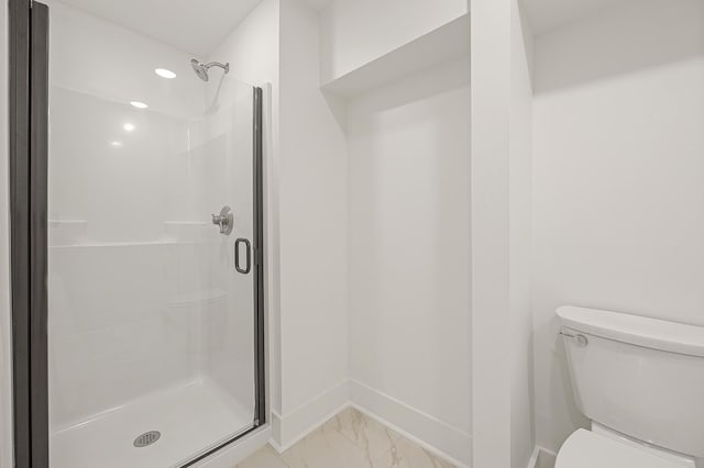 full bathroom with marble finish floor, a stall shower, and toilet