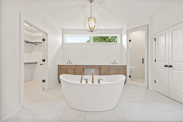 bathroom with a sink, marble finish floor, a soaking tub, and a shower stall