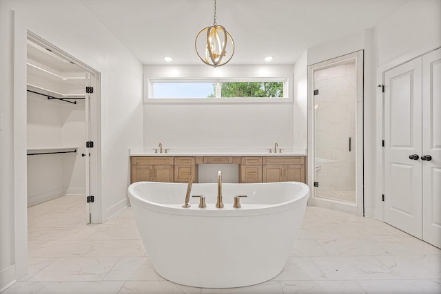 bathroom with a freestanding tub, baseboards, marble finish floor, double vanity, and a stall shower