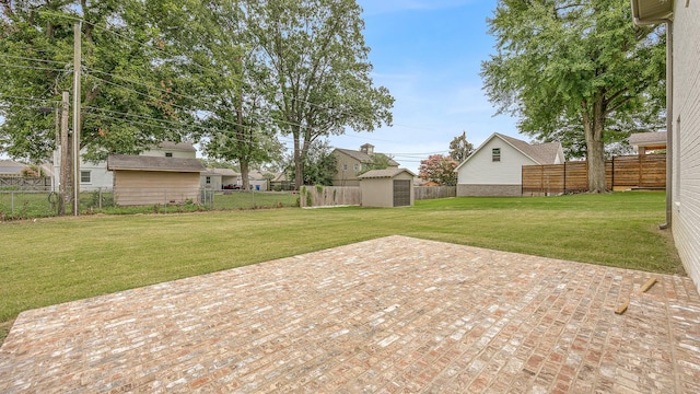 view of patio with a storage shed, a fenced backyard, and an outdoor structure