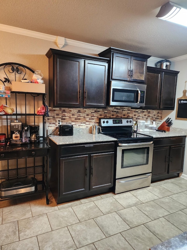 kitchen with crown molding, decorative backsplash, appliances with stainless steel finishes, a textured ceiling, and light stone countertops