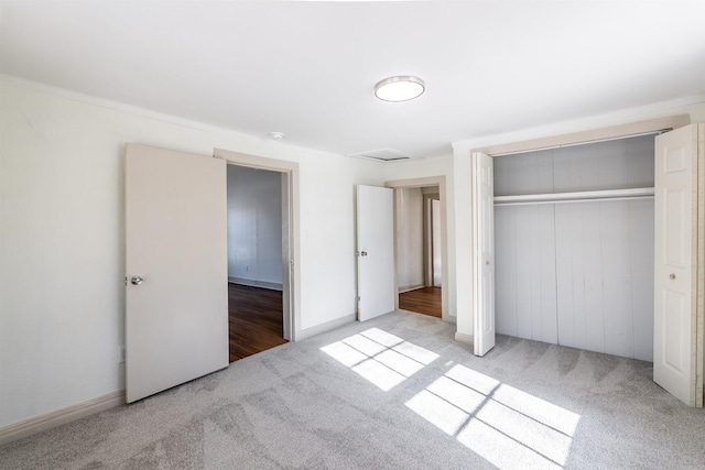 unfurnished bedroom featuring a closet and light carpet