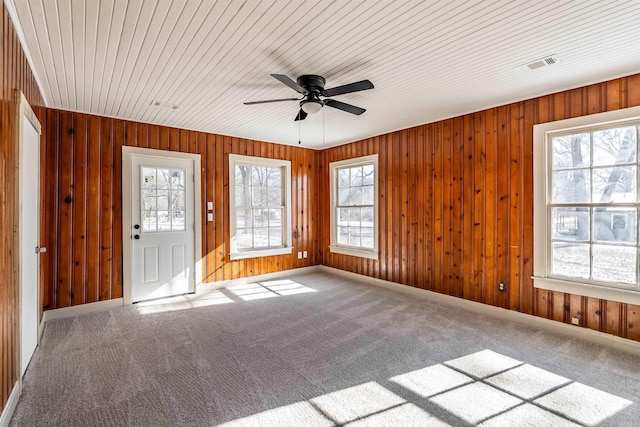 interior space featuring carpet, visible vents, ceiling fan, and baseboards