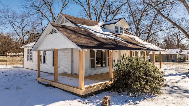 view of snow covered exterior featuring fence