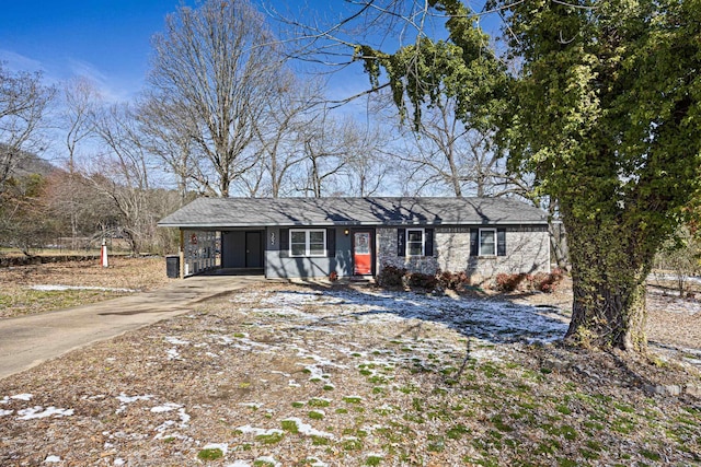 ranch-style home with an attached carport and driveway