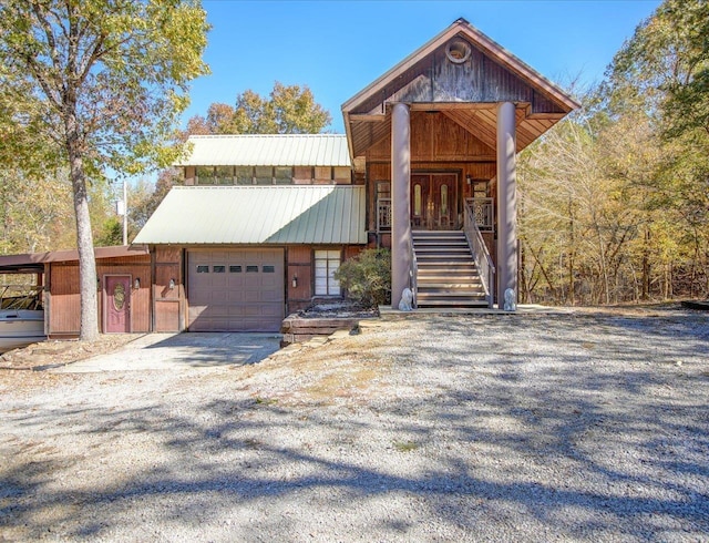 view of front of property with metal roof and driveway